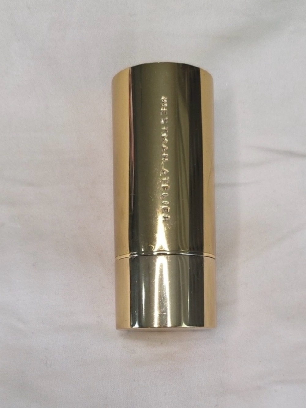 Westman Atelier lit up highlight stick in Brulee.